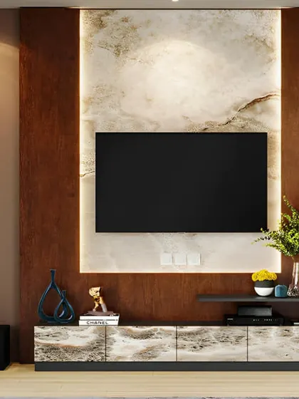 This design makes a bold statement with a dark, textured back panel and a marble-look console. The backlighting around the panel creates a stunning halo effect, highlighting the TV as the room's centerpiece.