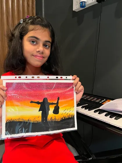 Our students are multi-talented! Here's our piano student Gaby showing off a beautiful piece of art she created, inspired by her love for music.