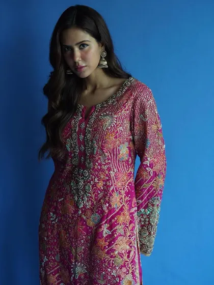 The contrast of the vibrant pink against the bold blue background makes this image of Sonam Bajwa pop. It’s a perfect example of using color to make a statement.