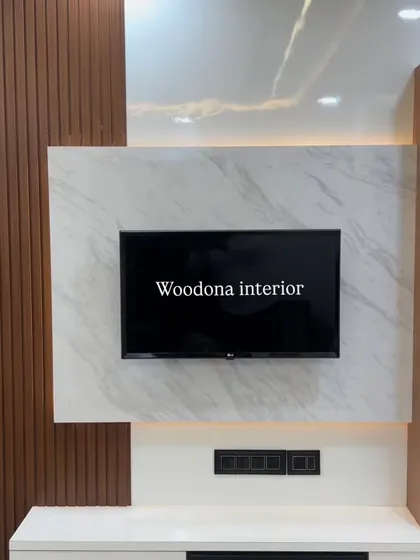 A closer look at the details of this media wall, highlighting the contrast between the warm wood grain of the fluted panels and the cool veining of the marble-style laminate.