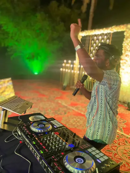 I don't just hide behind the deck. I'm an interactive wedding DJ and MC, getting on the mic to hype up the crowd and make sure the energy on the dance floor never drops.