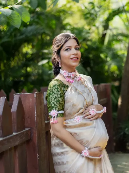 A lovely portrait of an expecting mother cradling her baby bump. Her serene expression and the soft, natural light make this a timeless maternity photograph.