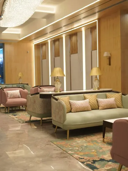 A seating area in the GCC Hotel lobby, where I used a mix of pastel green and pink upholstery. The custom-designed sofas and armchairs are complemented by elegant lighting and patterned cushions.