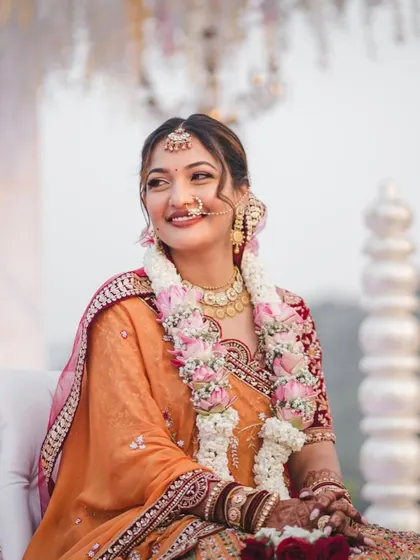A beautiful moment during the ceremony. Her hair is adorned with a garland, and the updo holds perfectly, looking graceful and elegant.