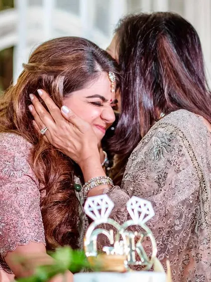A tender moment between the bride and her mother. A forehead kiss and a warm embrace, full of love and emotion.