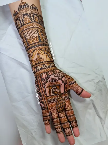Mehndi for the groom's sister, featuring dhol shehnai, swans, peacocks, and lotus elements. It's a design that is both celebratory and elegant, perfect for a close family member.