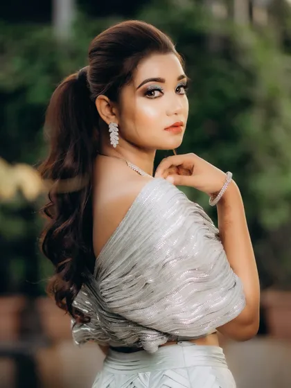 A graceful portrait of the bride looking over her shoulder. Her pose is elegant, and the soft background helps to make her the complete focus of the image.