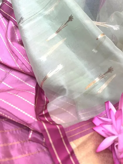 The unique motifs of a Tissue Silk saree. This image displays the delicate, woven patterns on the pallu, showing the artistry involved in creating these feather-light drapes.