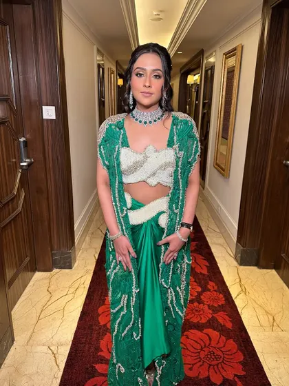 A bohemian-inspired half-updo with soft waves and small, decorative gold accessories. This look is perfect for a Mehendi or a relaxed, outdoor event.