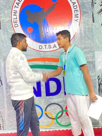 A handshake of respect and congratulations. This champion from my DTSA team earned his medals at the Late Jai Kishan Memorial Taekwondo Championship.
