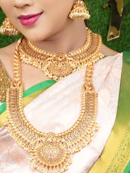A close-up of a beautiful temple jewellery set with pearl detailing. You can see the intricate work on the choker and haram.