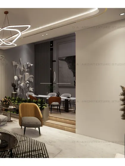 A view showing the transition from the living area to a raised dining space, using levels and a large sculptural plant to create distinct yet connected zones.