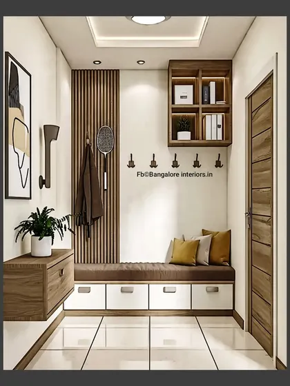 This cozy foyer nook features a floating cabinet, a long bench with storage drawers, and coat hooks. The wood slat accent wall adds a touch of modern texture.