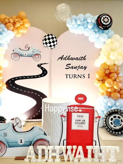 A vintage race car theme for Adhwaith Sanjay's first birthday. I used a soft pastel color palette and props like a retro gas pump and car cutout for a charming and stylish look.