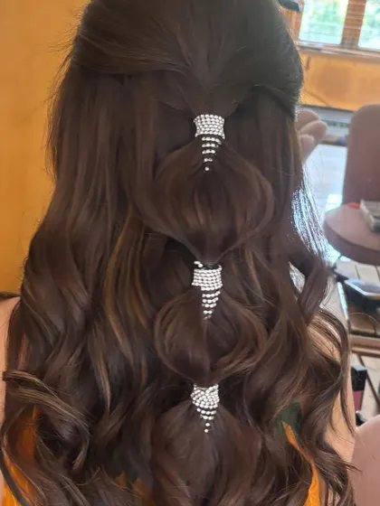The full view of the crystal-cuffed bubble ponytail. The combination of soft waves and modern accessories makes this a very popular and Instagram-worthy hairstyle.