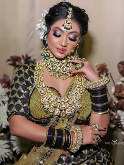 A soft and elegant portrait of the bride with her eyes closed. The focus is on her calm expression and the way the light catches the sparkle of her jewellery and outfit.