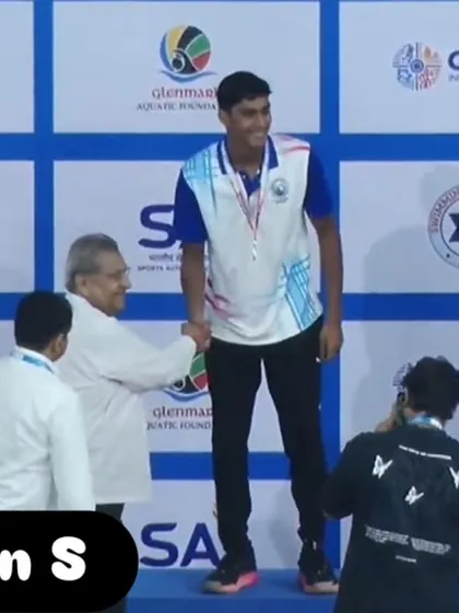 Dharshan S receiving his silver medal on the podium.