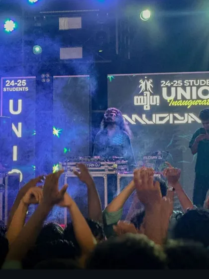 On stage at the YUGA union inauguration, with the crowd's hands raised in the air.