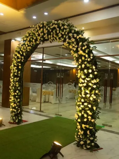A closer look at one of the dense floral arches, showcasing the quality of the white flowers and the integrated lighting that makes it stand out.