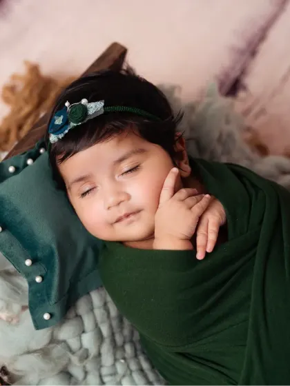 Sweet dreams. A sleeping newborn, peacefully posed, showcasing their delicate features.