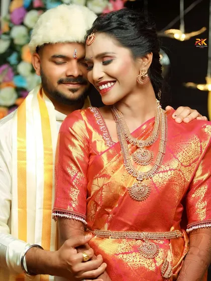 A warm and loving portrait of the couple after their wedding ceremony. The groom embraces his bride as they share an intimate, happy moment together.