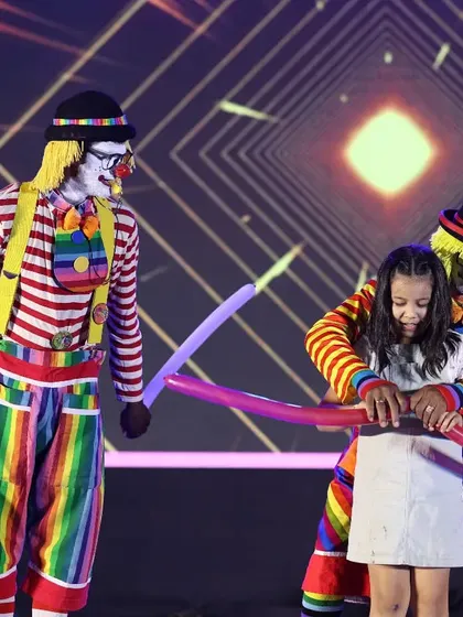 Nothing brings more joy to a child's face than our interactive clown acts. Here, our performers engage directly with a young audience member, creating a special and memorable moment with fun balloon props.