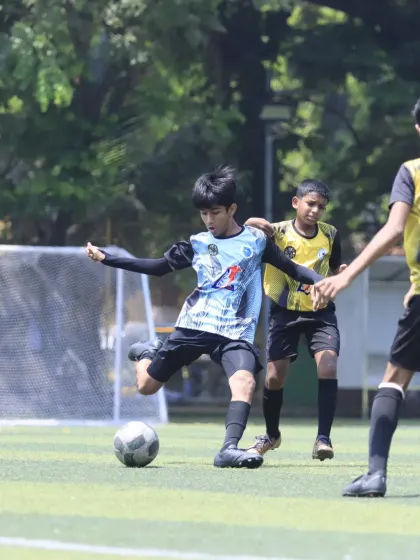 A player takes a powerful shot on goal, demonstrating the shooting practice and technique learned at the academy.