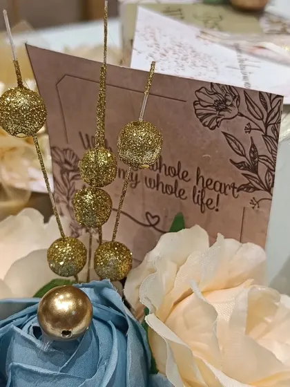 A detail shot of the engagement hamper, with glittery decorative elements and a heartfelt card.