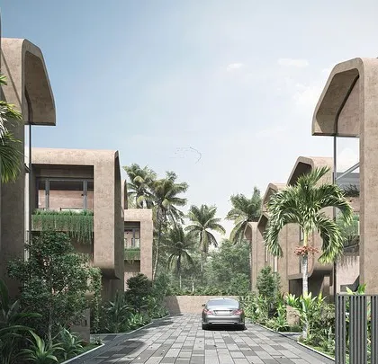 The street view of the Vagator Villas shows how the repeated forms create a cohesive neighborhood feel. The use of earthy plaster and minimal lines helps the architecture settle into the tropical context of Vagator, Goa.