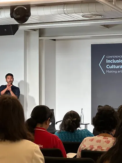 A sign language interpreter at the conference on making arts accessible. This visual is a powerful reminder that inclusive design must consider a wide spectrum of human experience and ability.