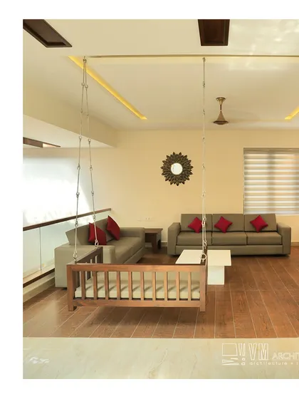 The family living area upstairs in the Adoor residence, featuring a traditional wooden cradle swing for a cozy, nostalgic touch.