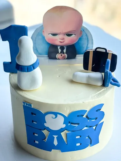 A closer look at the Boss Baby cake, showing the printed topper and fondant details.