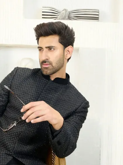 This angle of the black Jodhpuri suit emphasizes its sharp cut and how it sits perfectly on the shoulders. It’s a modern classic for the discerning man.