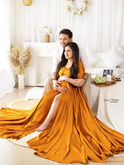 A glamorous and loving portrait of the couple on our studio bed set. The flowing golden gown adds a touch of luxury to this intimate scene.