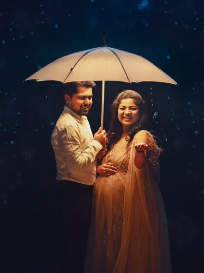 A happy and interactive version of the rain shoot, with the couple smiling and catching the "raindrops."