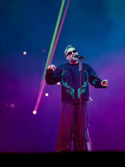 Yo Yo Honey Singh performing with multi-colored lasers crossing in the background. This shot showcases the high-tech production of his Millennium Tour.