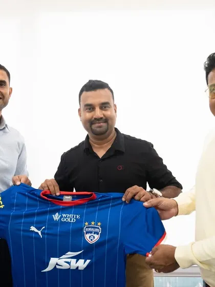 Director of Football Darren Caldeira formalizes the partnership with H16 Sports, holding up the iconic BFC jersey.