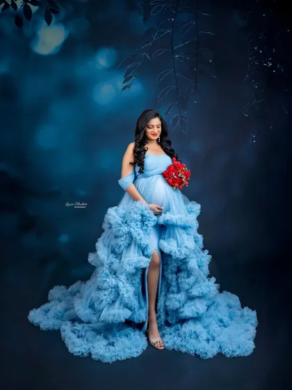 A darker, more moody take with the blue ruffled gown. The red bouquet adds a striking point of contrast.