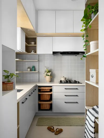 A compact U-shaped kitchen design that maximizes storage and counter space, featuring open shelving and pull-out wicker baskets for vegetables.