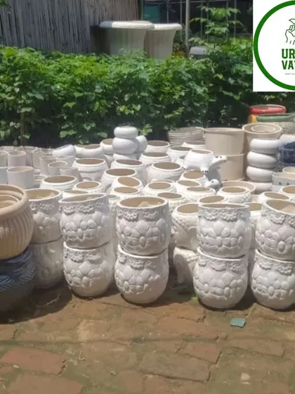 A batch of white ceramic pots with a lace-like texture.