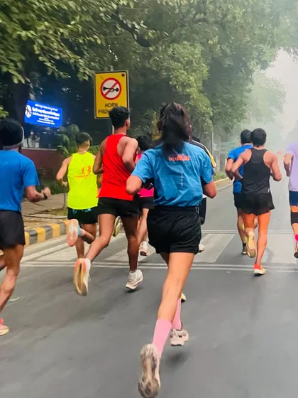 My athletes running on the road during our India Gate run. The mix of male and female runners showcases the inclusive nature of our training group.