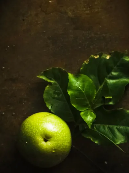 A minimalist shot of a passion fruit on a rustic surface, highlighting the raw ingredient.