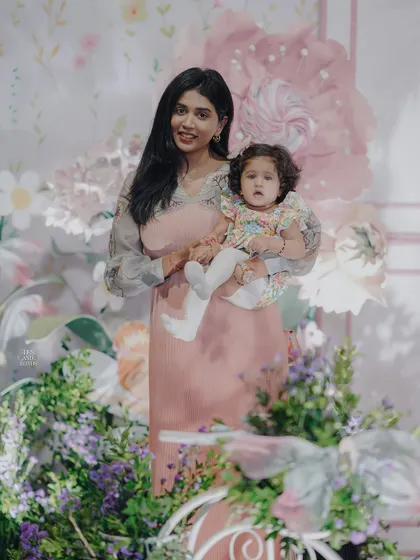 A beautiful portrait of a mother and her daughter amidst the enchanting floral decor. My goal is to create a picturesque setting that enhances the beauty of your special family moments.