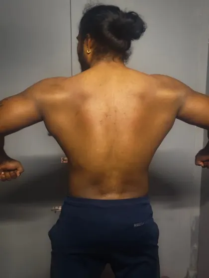 Here I am demonstrating a back lat spread. This pose creates the illusion of a wider V-taper and is essential for a complete bodybuilding presentation.