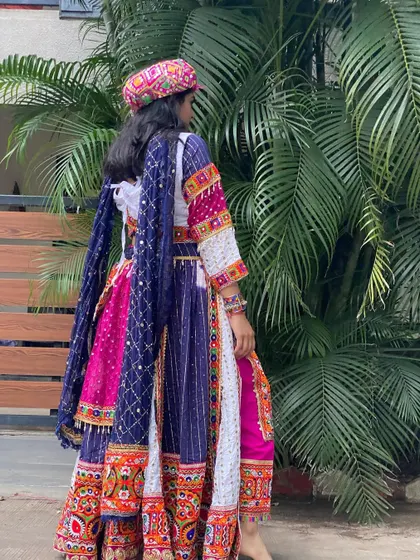 A back view of the dhoti-style outfit, highlighting the drape of the dupatta and the fit of the ensemble.
