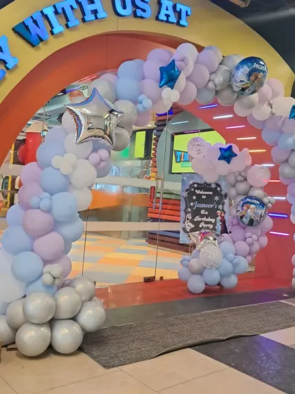 A beautiful balloon arch frames the entrance to our play area for a Frozen-themed party. The silver and blue colors perfectly match the wintery theme, complete with character balloons.
