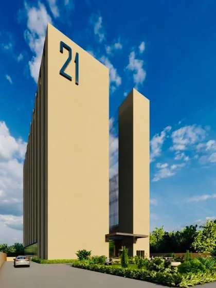 An angled perspective of the "21" office building, showing how the solid volumes create a strong silhouette against the sky. This design prioritizes sustainability without sacrificing a bold architectural statement.