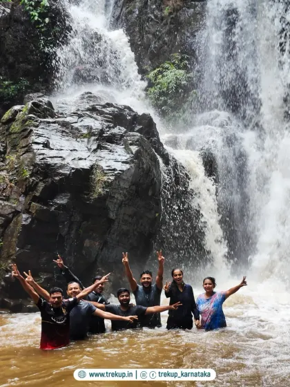 A group celebrating in the water at the base of a powerful waterfall. This is what pure, unadulterated fun looks like on a Trekup trip.