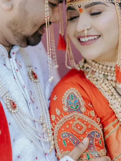 A close-up shot focusing on the bride's joyful expression and the intricate embroidery on her blouse during a Maharashtrian wedding.