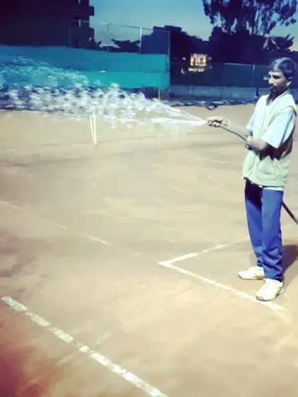 My staff performs daily court maintenance, watering the clay surface to ensure optimal playing conditions for every tournament match.